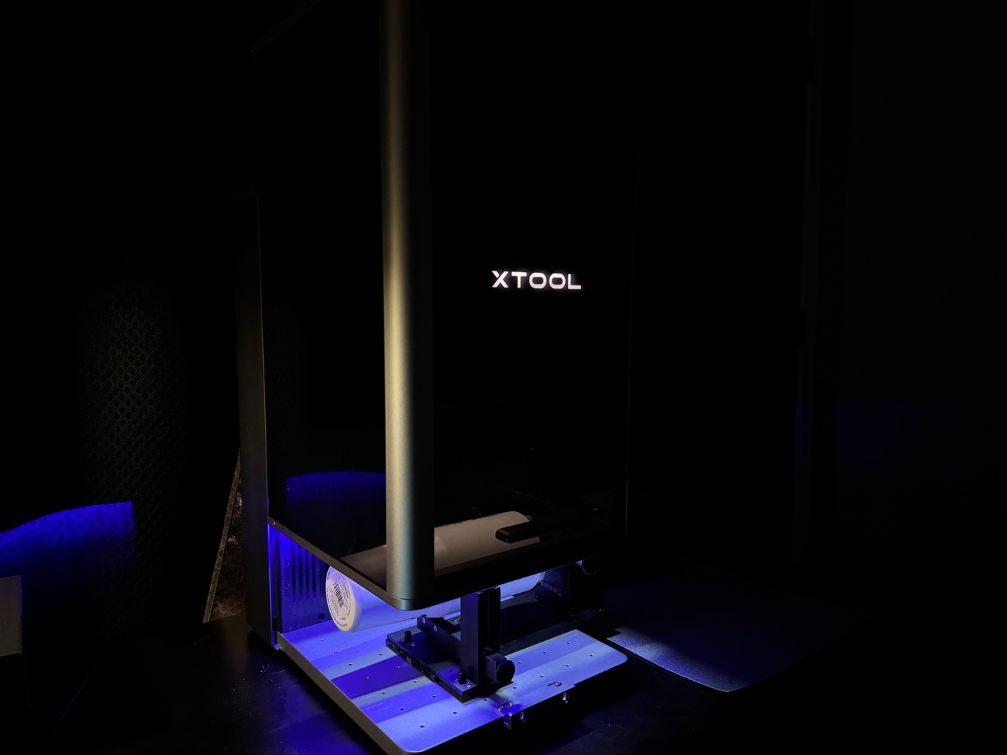 xTool F2 Ultra laser machine glowing blue in the studio