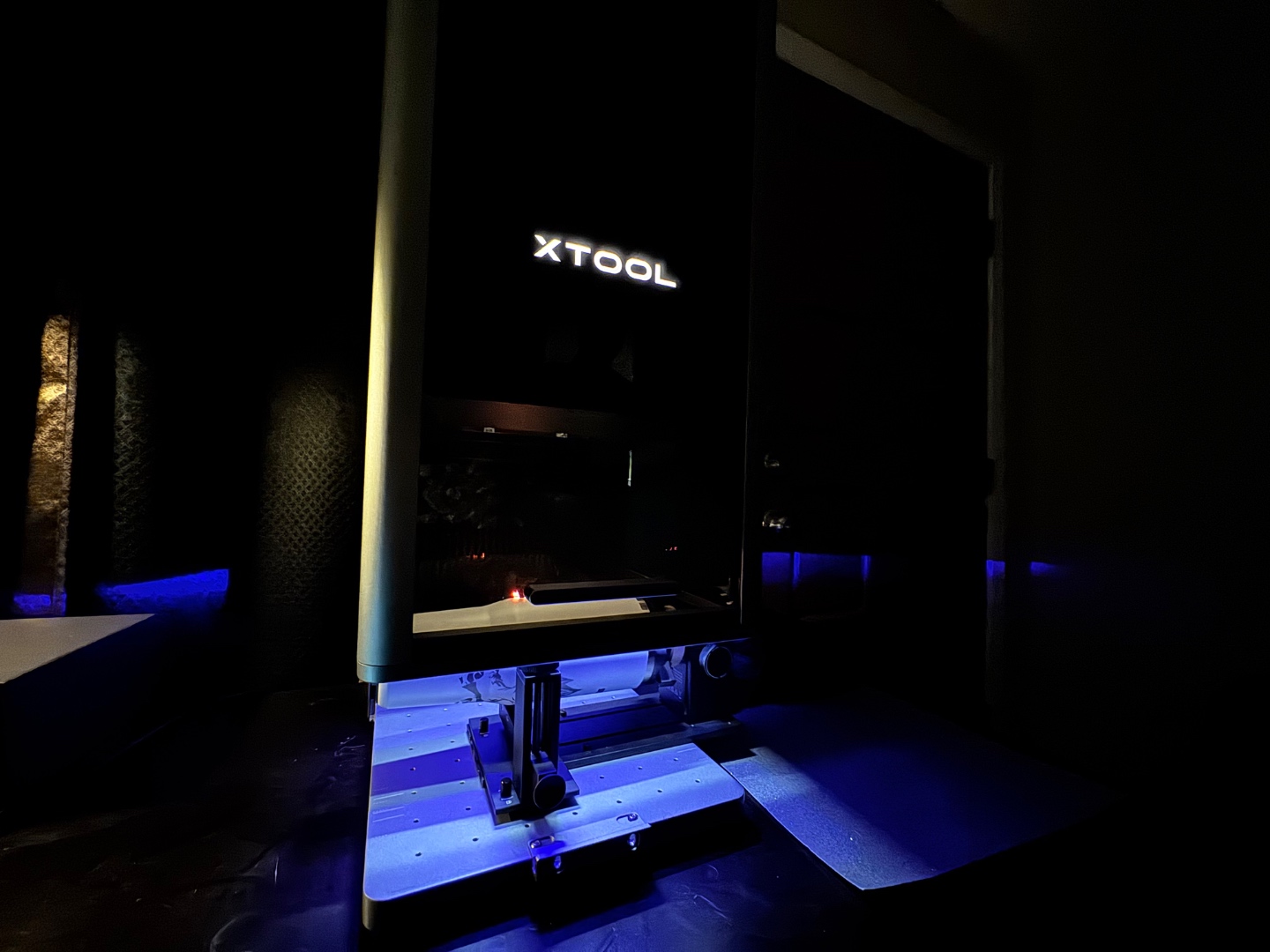 xTool laser machine at a different angle, blue chamber lit