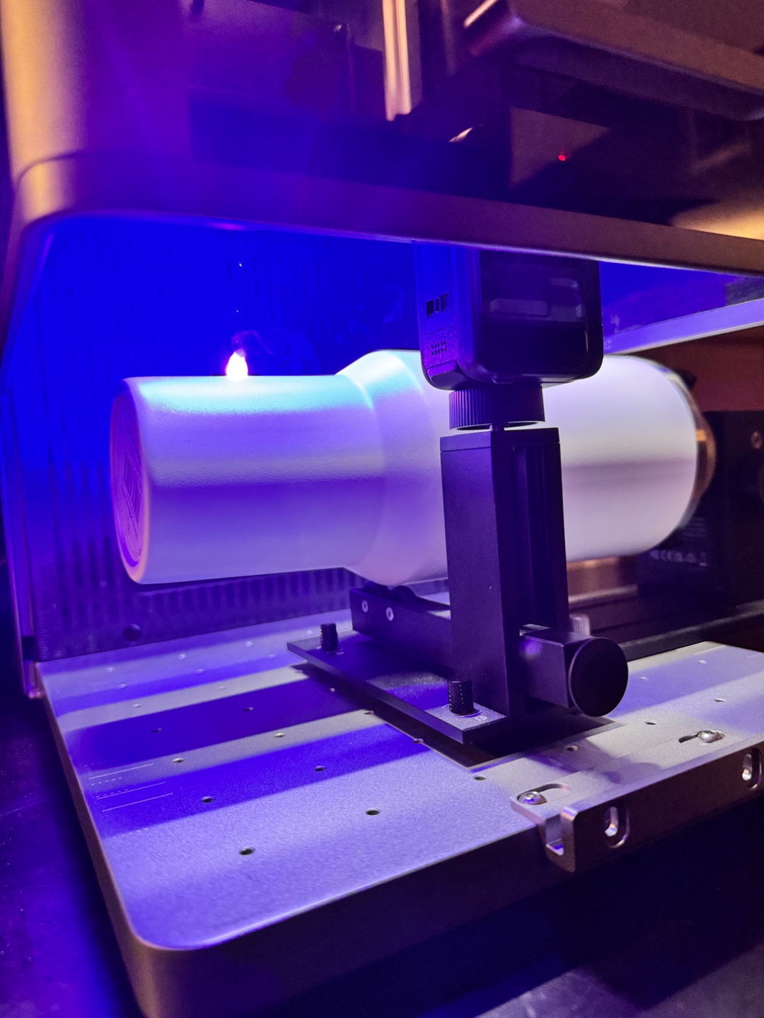 Stanley tumbler in the rotary attachment under the laser engraver